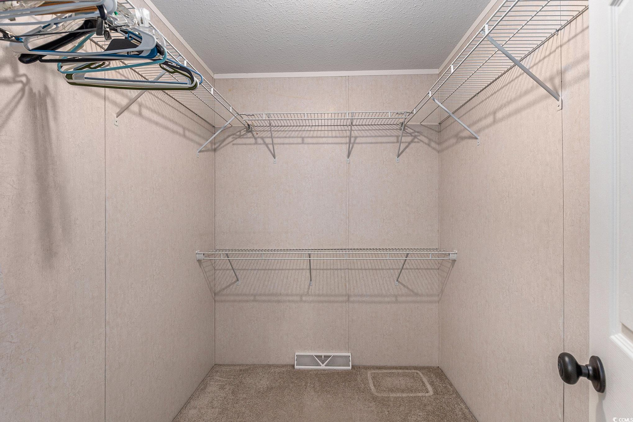 237 Wellspring Drive Conway, SC 29526 - Photo 22 of 33 Full bathroom with a textured wall, vanity, shower / washtub combination, crown molding, and light tile patterned flooring