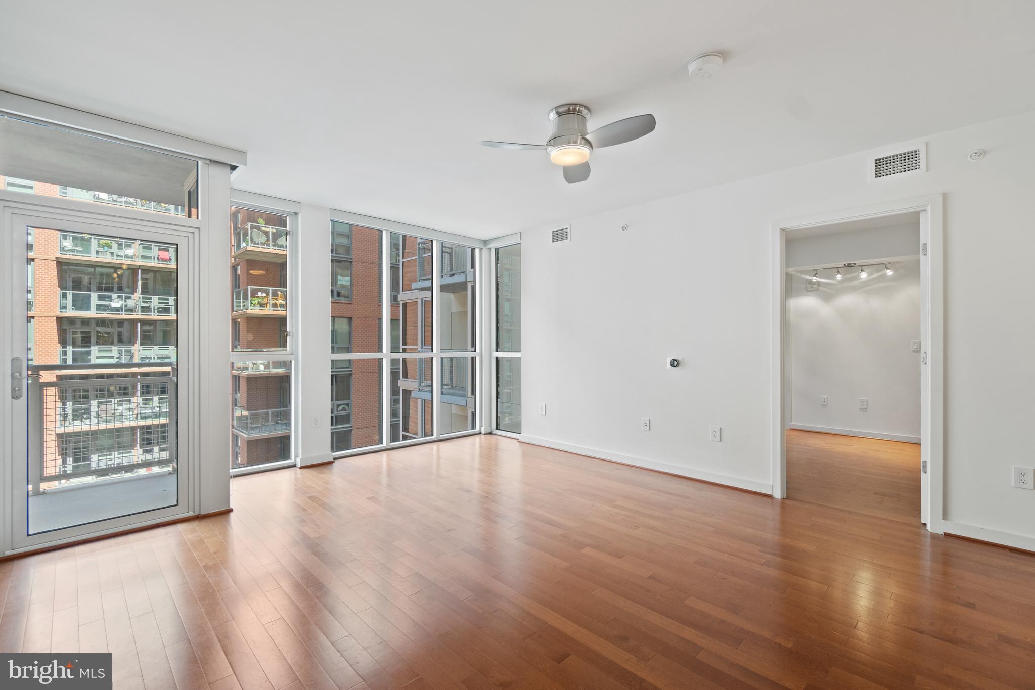 1025 First Street Southeast, Unit 801 Washington, DC 20003 - Photo 5 of 22 a view of an empty room with wooden floor and a window