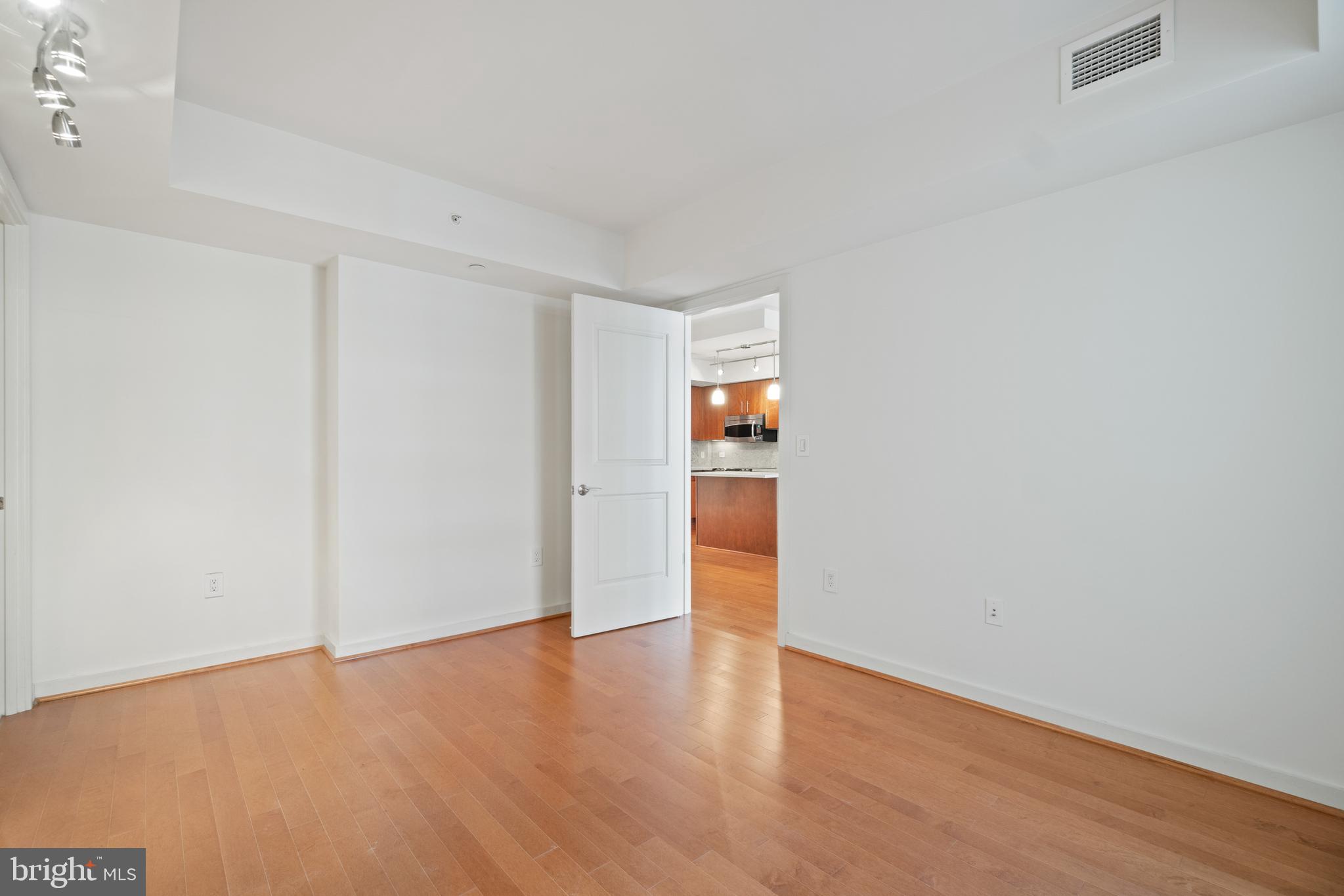 1025 First Street Southeast, Unit 801 Washington, DC 20003 - Photo 10 of 22 a view of an empty room with wooden floor