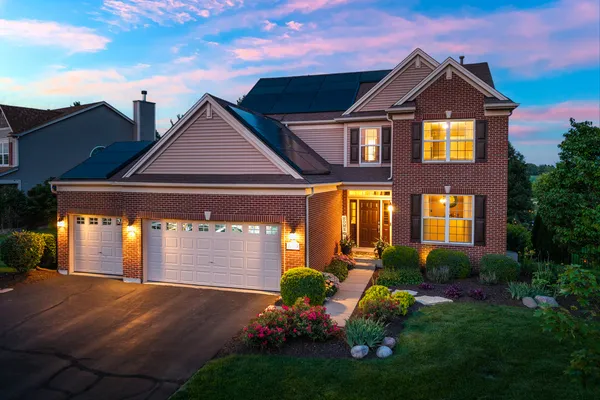 a front view of a house with a yard and garage