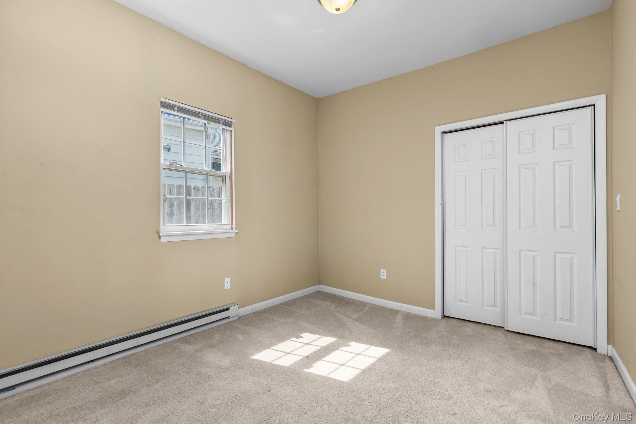 10 Batavia Road Patterson, NY 12563 - Photo 22 of 42 Carpeted room with a double-paned window and baseboard heating