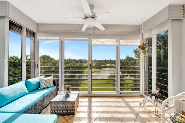 a living room with furniture a chandelier and a window
