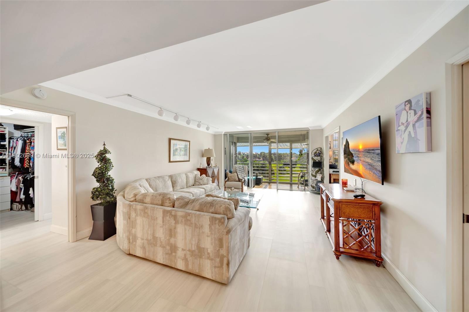 3980 Oaks Clubhouse Drive, Unit 409 Pompano Beach, FL 33069 - Photo 11 of 70 a living room with furniture and a flat screen tv