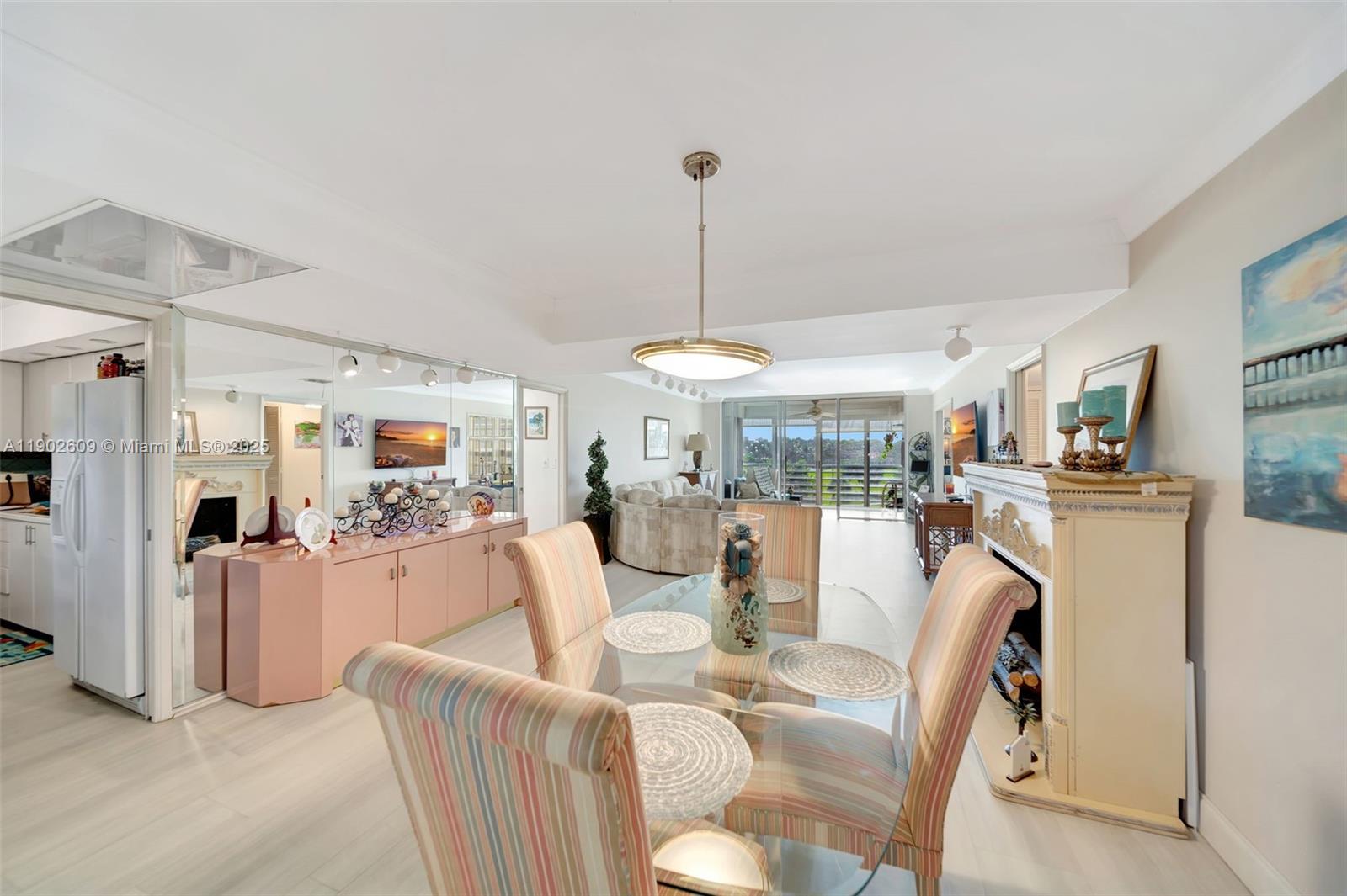 3980 Oaks Clubhouse Drive, Unit 409 Pompano Beach, FL 33069 - Photo 12 of 70 a view of a dining room with furniture window and outside view