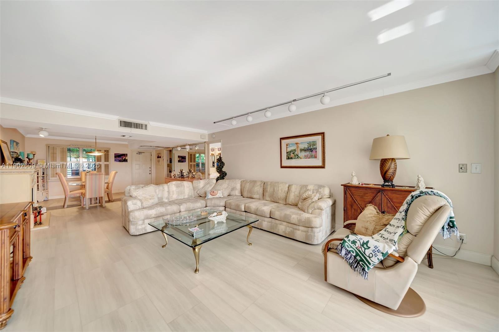 3980 Oaks Clubhouse Drive, Unit 409 Pompano Beach, FL 33069 - Photo 19 of 70 a living room with furniture rug and lamp