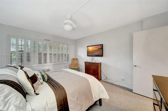 a bed room with a bed and a tv