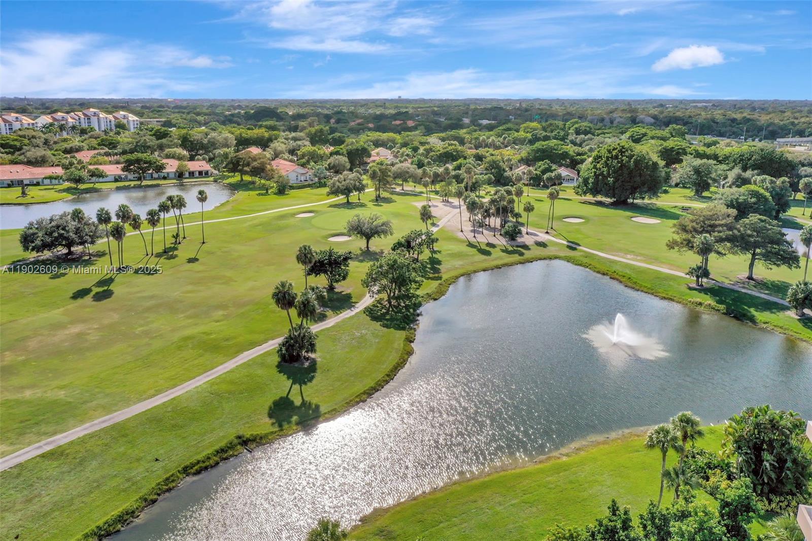 3980 Oaks Clubhouse Drive, Unit 409 Pompano Beach, FL 33069 - Photo 2 of 70 Enjoy serene golf course living with wide fairways, water features, and palm-dotted greens. Peaceful walking paths and gorgeous lake views create the perfect backdrop for everyday relaxation.
