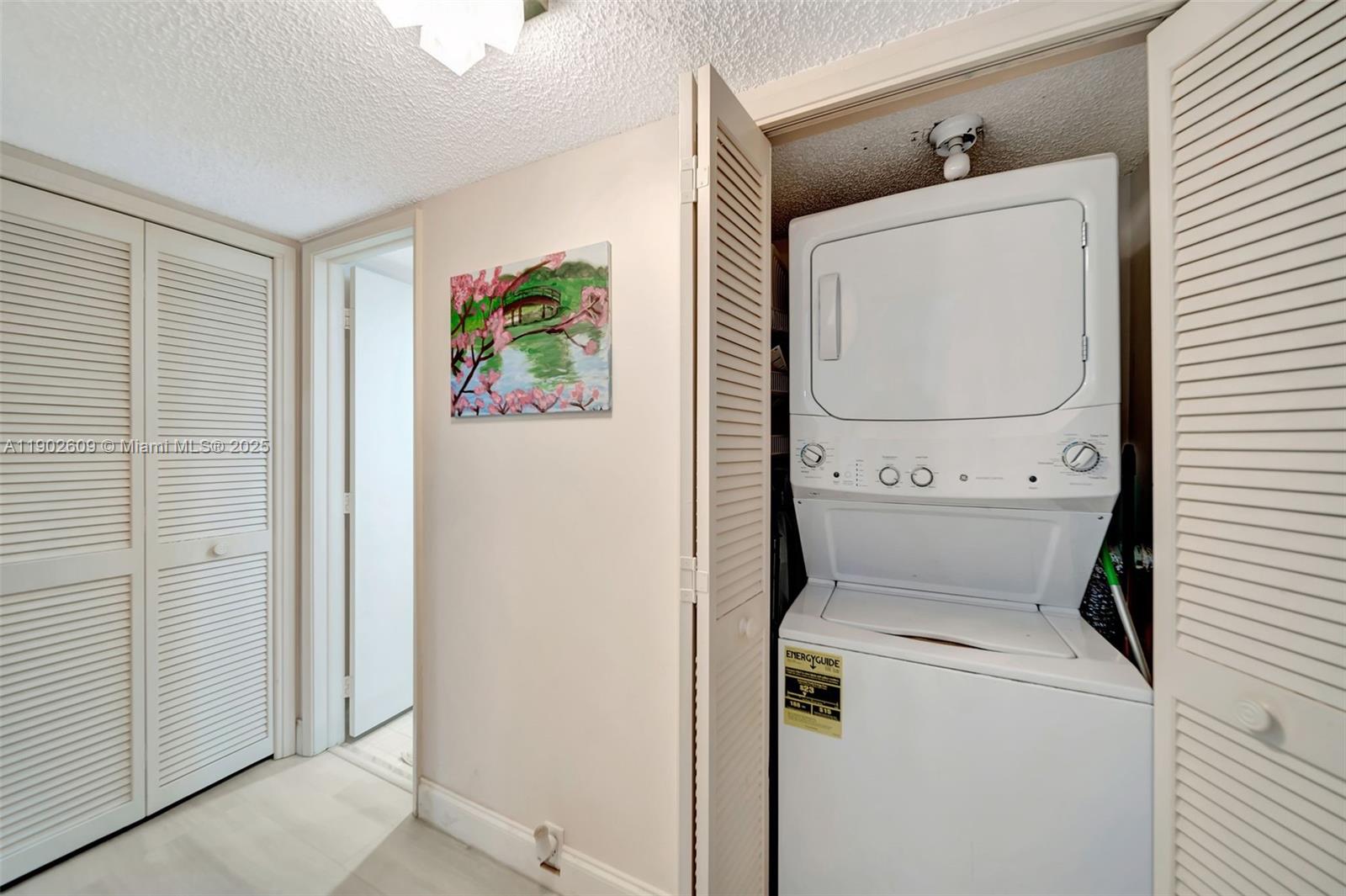 3980 Oaks Clubhouse Drive, Unit 409 Pompano Beach, FL 33069 - Photo 23 of 70 a utility room with dryer and washer