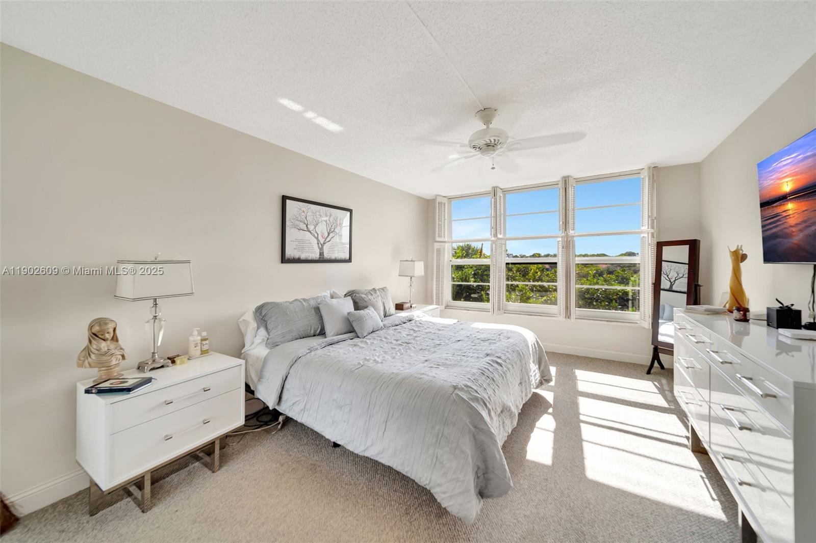 3980 Oaks Clubhouse Drive, Unit 409 Pompano Beach, FL 33069 - Photo 24 of 70 a spacious bedroom with a bed and a large window