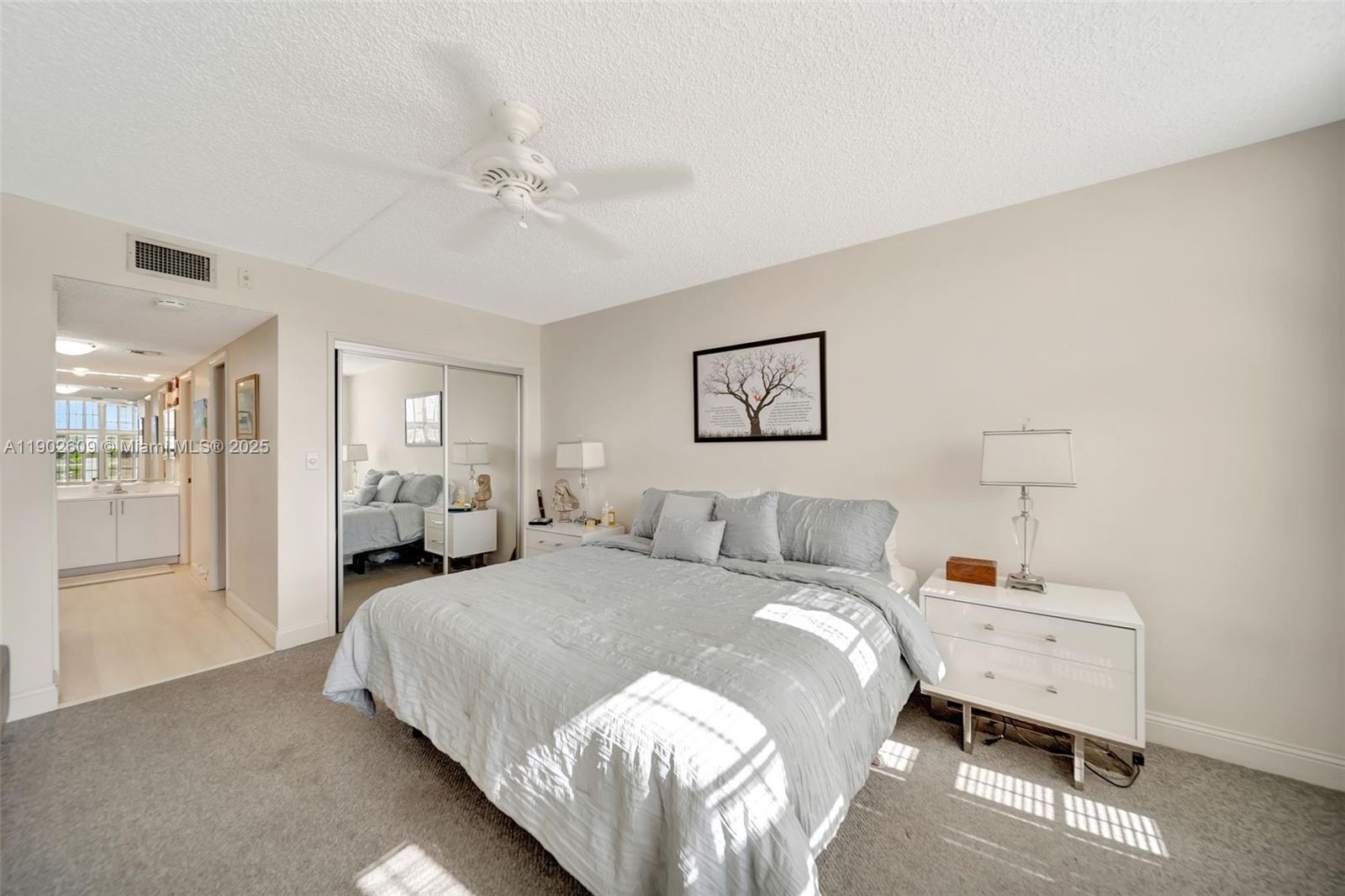 3980 Oaks Clubhouse Drive, Unit 409 Pompano Beach, FL 33069 - Photo 25 of 70 a bed room with a bed and a tv