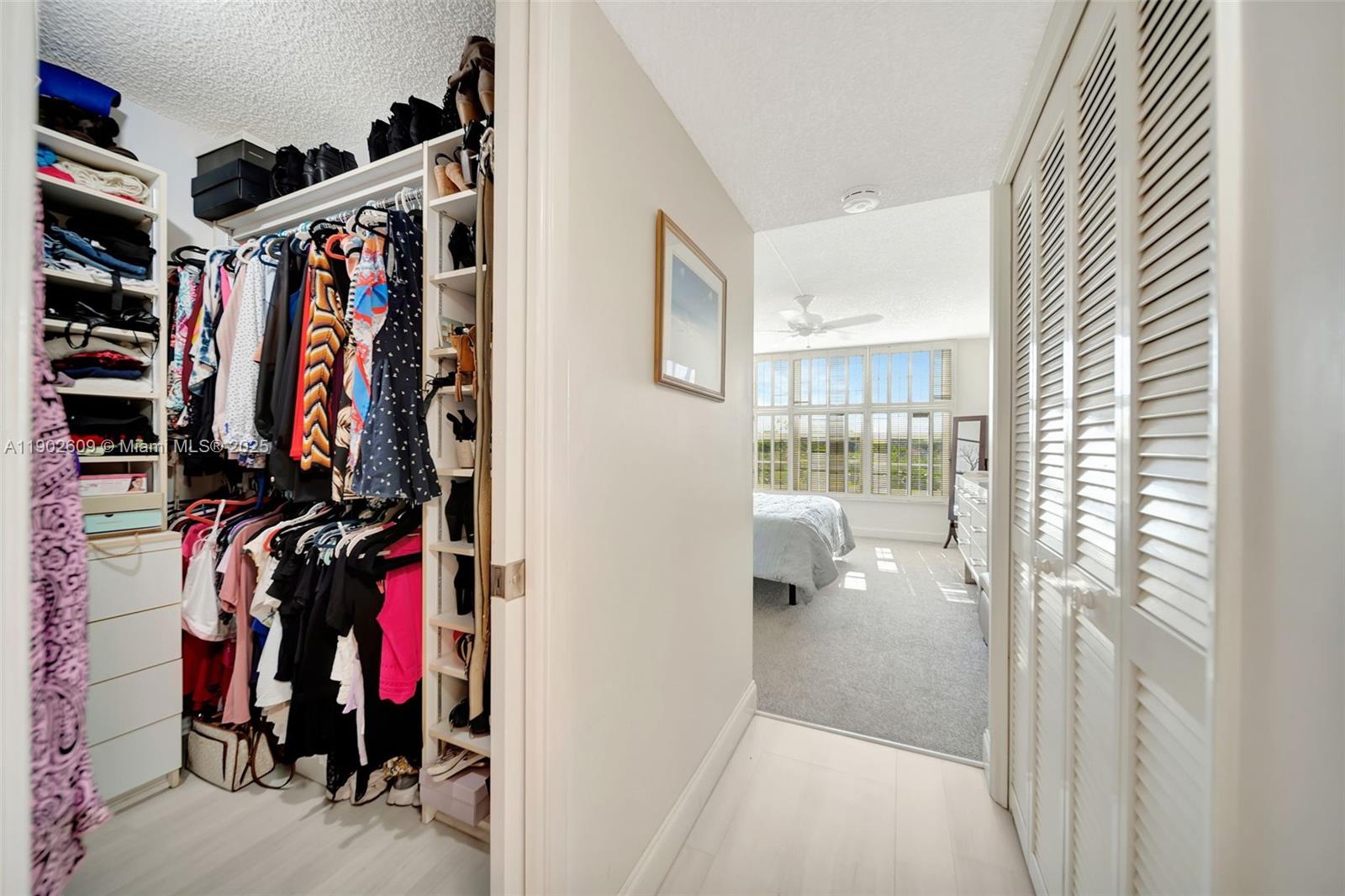 3980 Oaks Clubhouse Drive, Unit 409 Pompano Beach, FL 33069 - Photo 29 of 70 a view of walk in closet with clothes and shoes