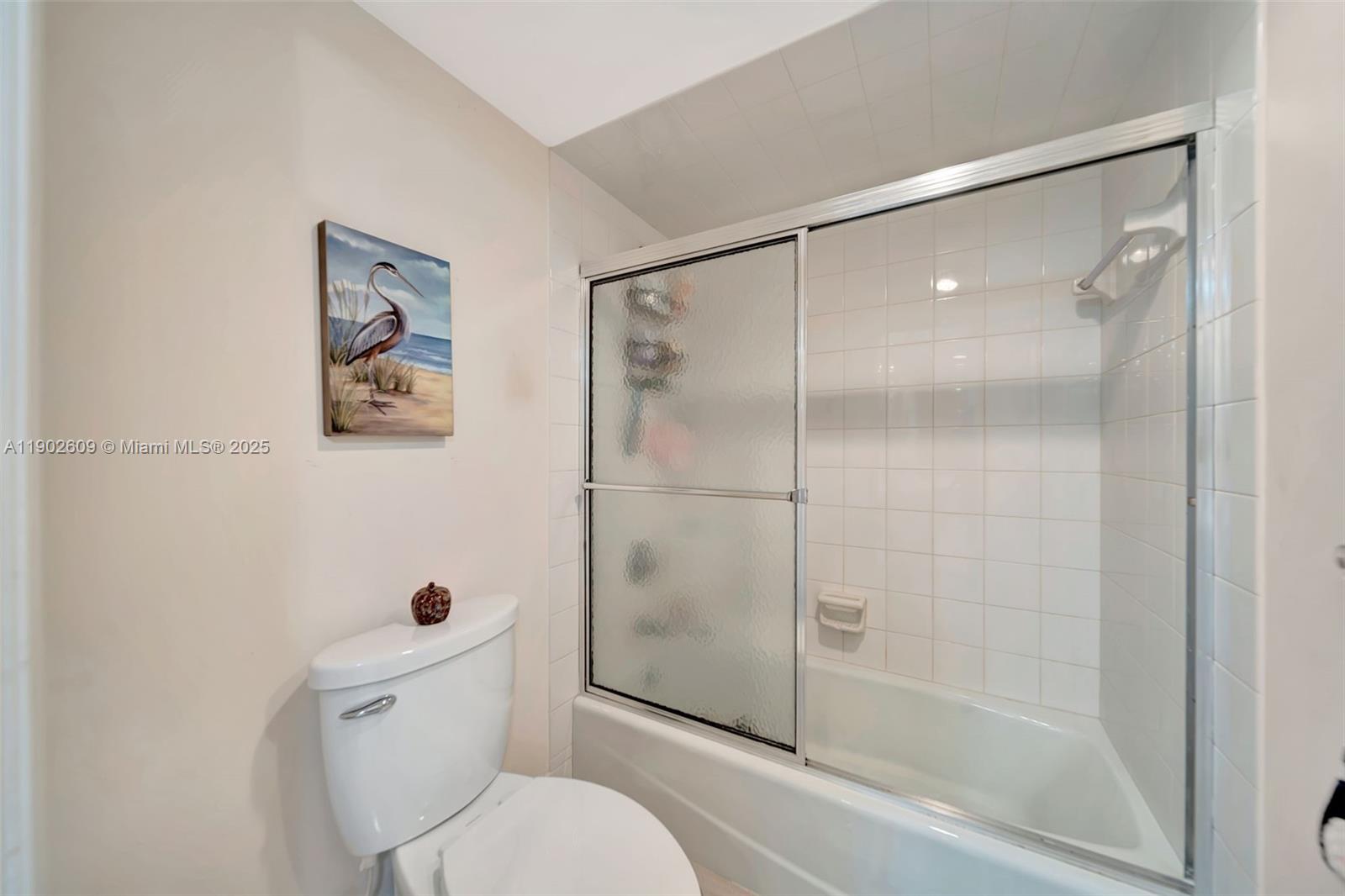 3980 Oaks Clubhouse Drive, Unit 409 Pompano Beach, FL 33069 - Photo 34 of 70 a bathroom with a toilet and a shower