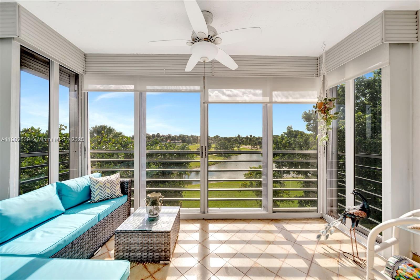 3980 Oaks Clubhouse Drive, Unit 409 Pompano Beach, FL 33069 - Photo 44 of 70 a living room with furniture a chandelier and a window