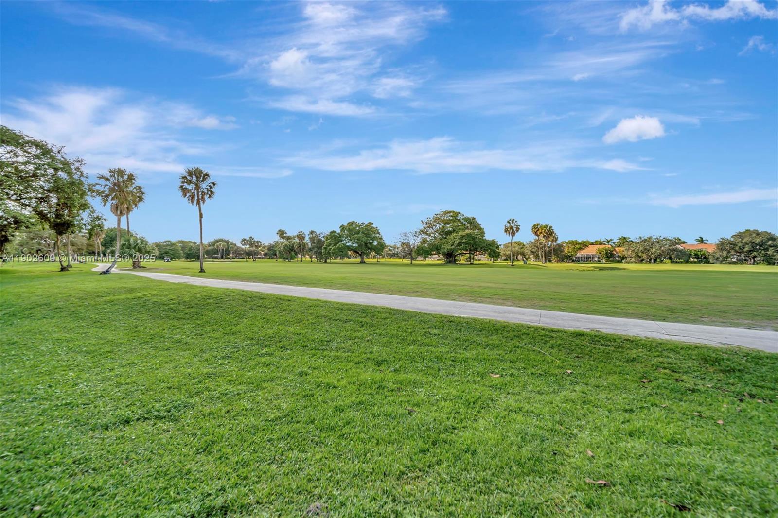 3980 Oaks Clubhouse Drive, Unit 409 Pompano Beach, FL 33069 - Photo 56 of 70 a view of a golf course with a lake