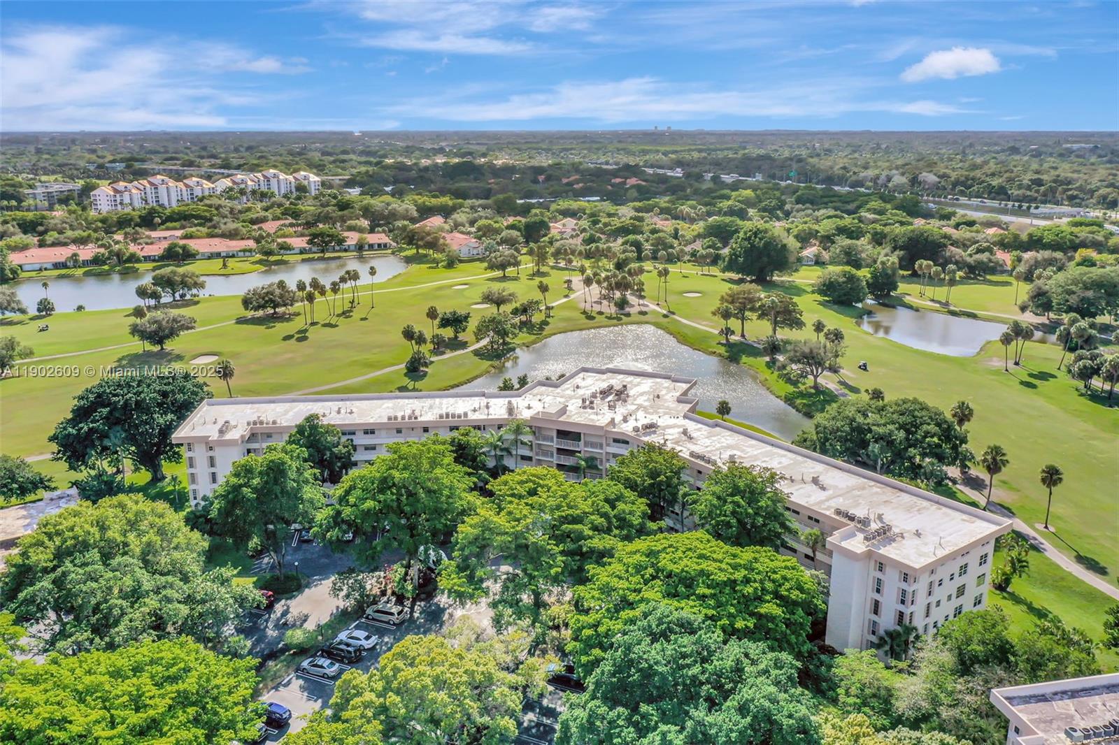 3980 Oaks Clubhouse Drive, Unit 409 Pompano Beach, FL 33069 - Photo 66 of 70 an aerial view of residential houses with outdoor space