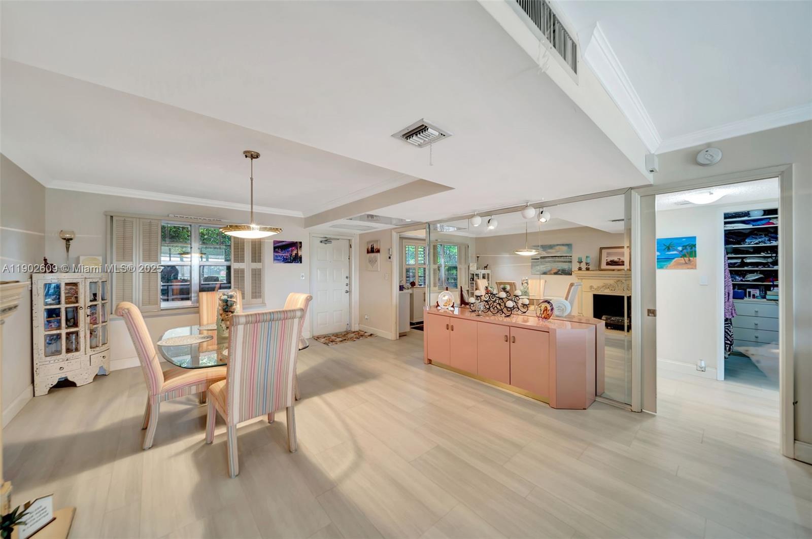 3980 Oaks Clubhouse Drive, Unit 409 Pompano Beach, FL 33069 - Photo 10 of 70 The open-concept dining and living space features neutral flooring, crown molding, and great natural light. There’s plenty of room for both casual gathering and formal dining, plus flexible layout options to fit your lifestyle.