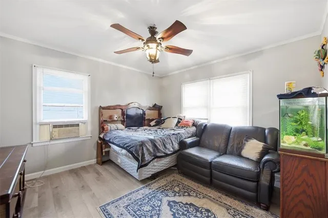a bedroom with a large window and a couch