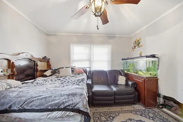 a bedroom with a bed couch and window
