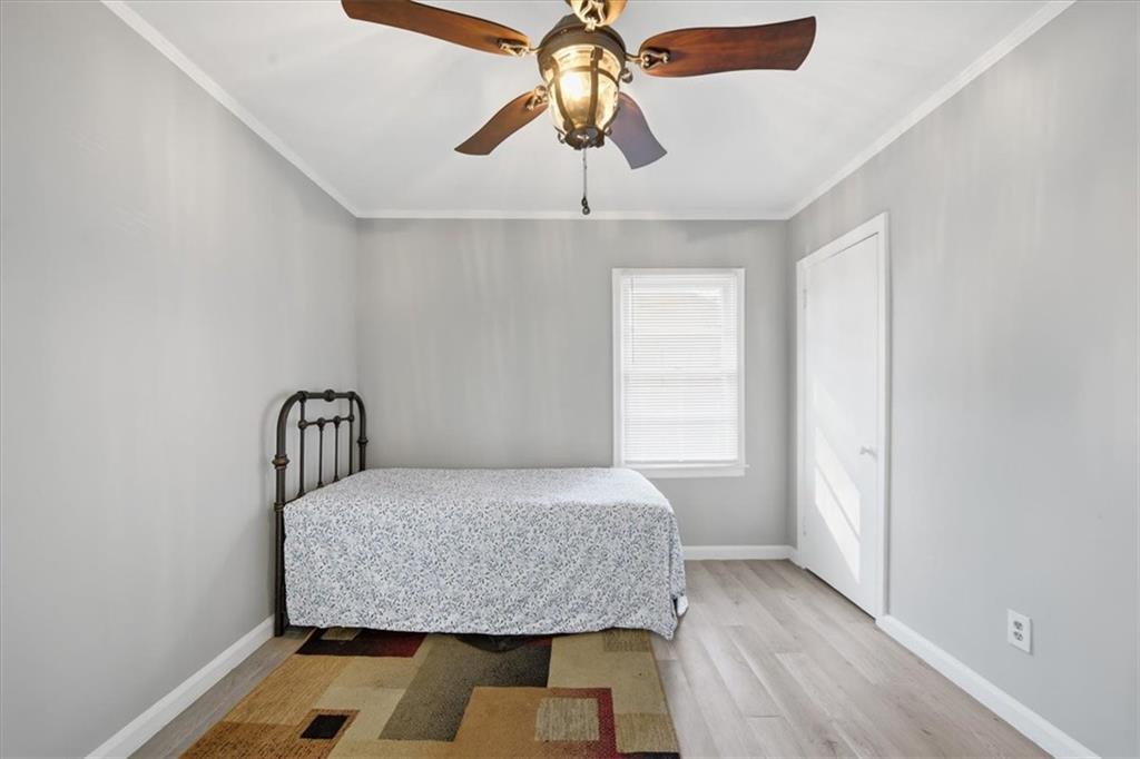 2363 Woodside Way Atlanta, GA 30341 - Photo 16 of 30 a bedroom with a bed and a chandelier