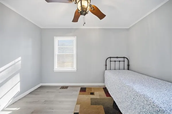 a bedroom with a bed and window