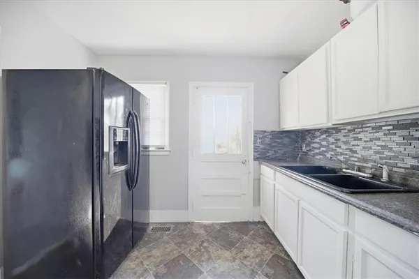a kitchen with a refrigerator and cabinets