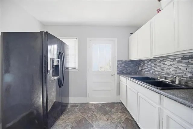 a kitchen with a refrigerator and cabinets