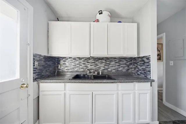 a view of a refrigerator and cabinets