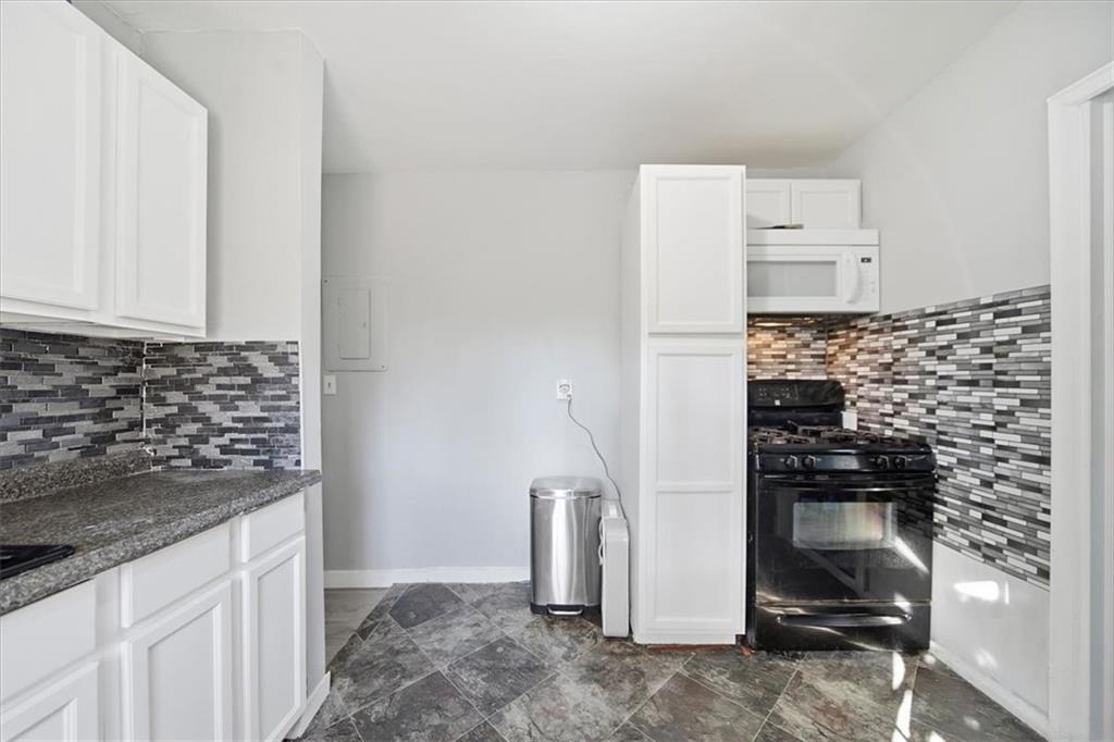 2363 Woodside Way Atlanta, GA 30341 - Photo 23 of 30 a kitchen with a refrigerator and a stove top oven