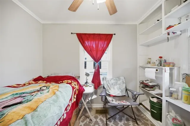 a bed room with a bed and a chair