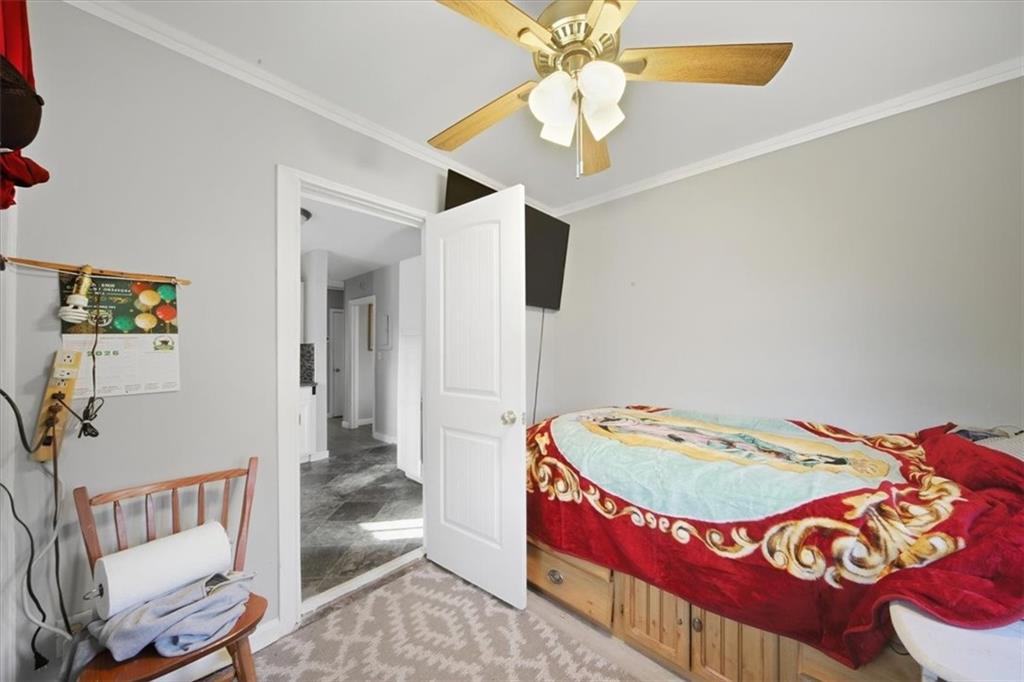 2363 Woodside Way Atlanta, GA 30341 - Photo 26 of 30 a bedroom with a bed and a chandelier