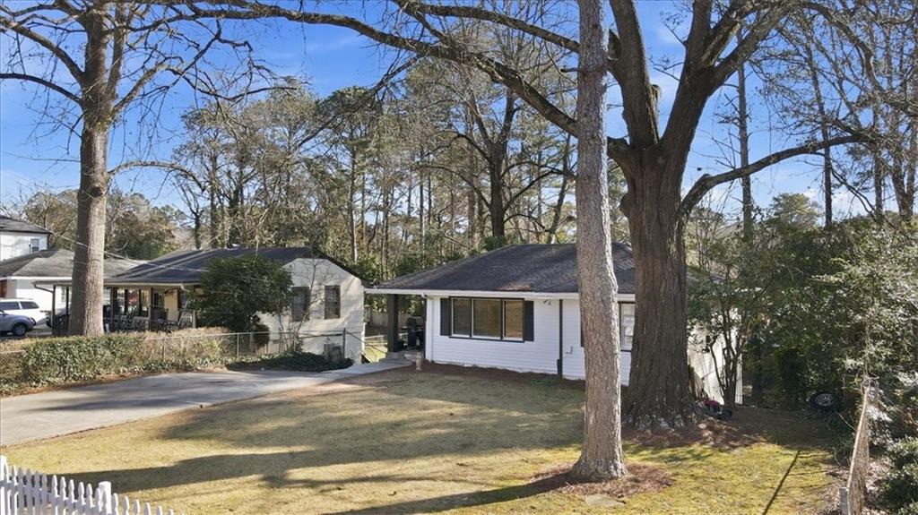 2363 Woodside Way Atlanta, GA 30341 - Photo 5 of 30 a white house that has a tree in front of it