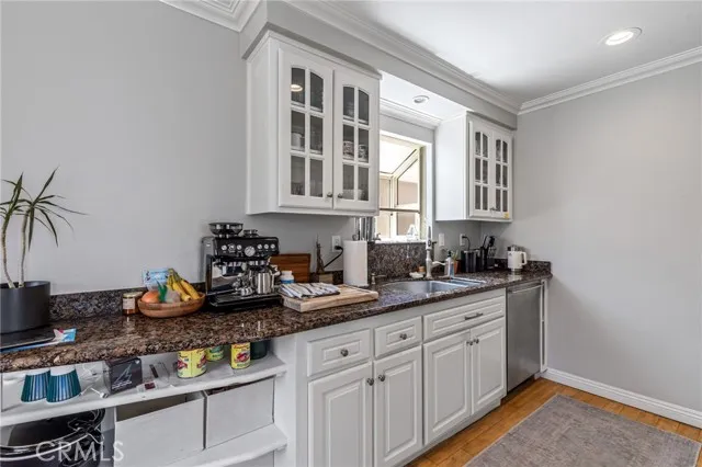 209 13th Street, Unit D Huntington Beach, CA 92648 - Photo 14 of 34 a kitchen with sink and cabinets