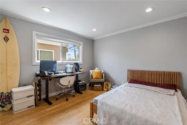 209 13th Street, Unit D Huntington Beach, CA 92648 - Photo 19 of 34 a bedroom with furniture and a window