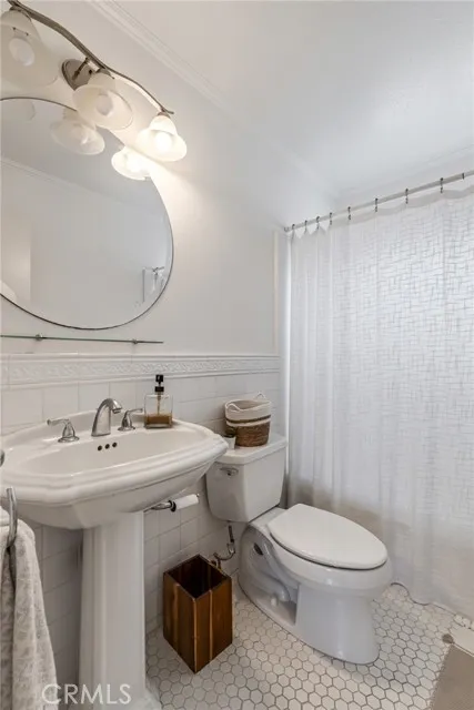 209 13th Street, Unit D Huntington Beach, CA 92648 - Photo 22 of 34 a bathroom with a sink toilet and shower