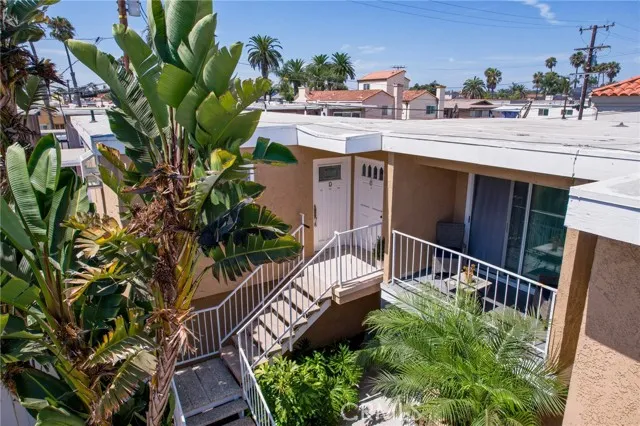 209 13th Street, Unit D Huntington Beach, CA 92648 - Photo 3 of 34 a view of a house with a flower garden