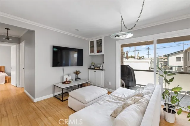 209 13th Street, Unit D Huntington Beach, CA 92648 - Photo 7 of 34 a bedroom with furniture and a flat screen tv