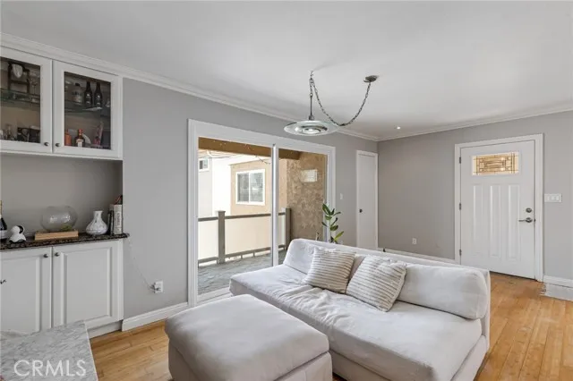 209 13th Street, Unit D Huntington Beach, CA 92648 - Photo 8 of 34 a living room with furniture and a chandelier