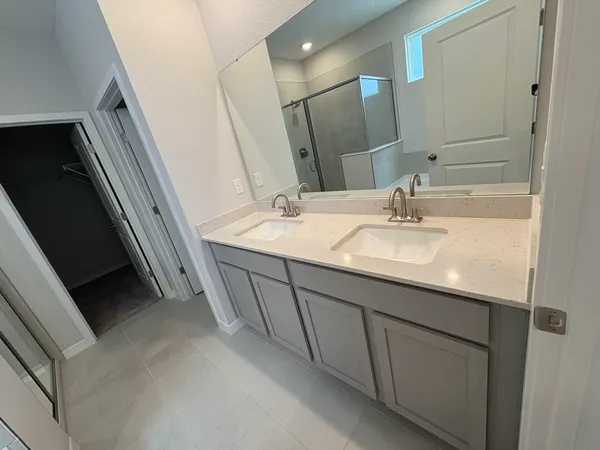 a bathroom with a double vanity sink and mirror