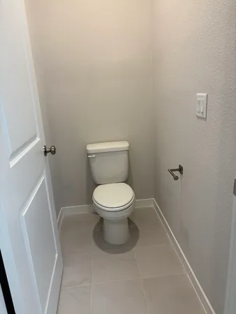 a white toilet sitting next to a white sink