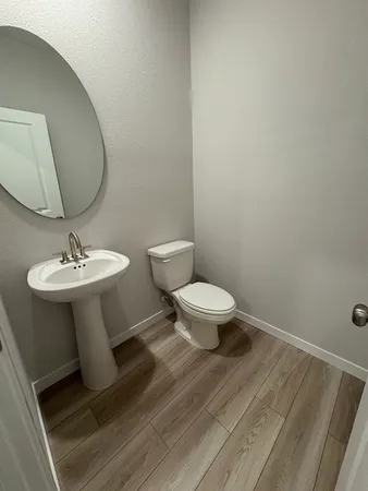 a bathroom with a sink toilet and mirror