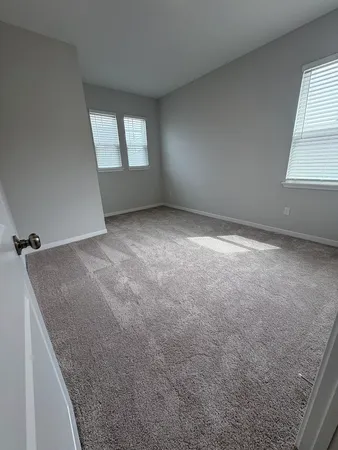 an empty room that has a window in it