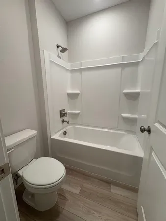 a bathroom with a toilet and a bathtub