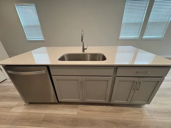 a kitchen with a sink and cabinets
