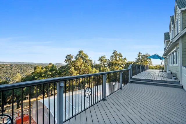 a view of a balcony with wooden chairs