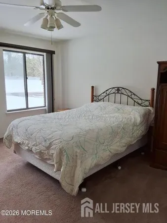 a large bed sitting in a bedroom next to a window