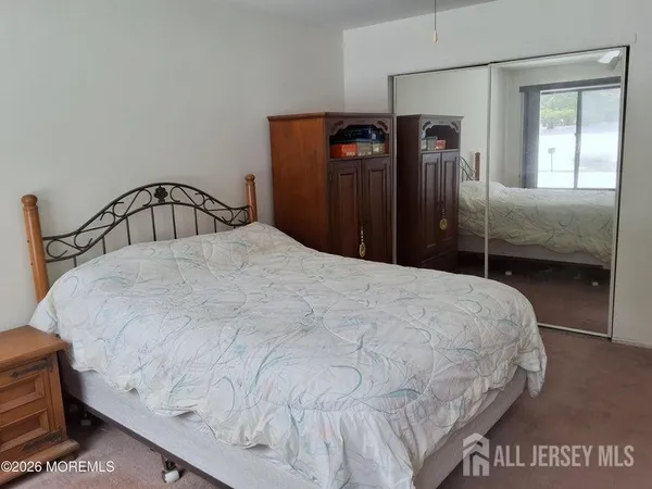 a bedroom with a bed and a table