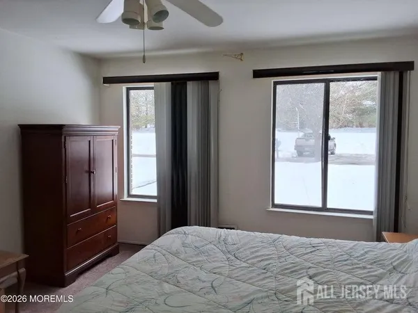 a bed sitting in a bedroom next to a window