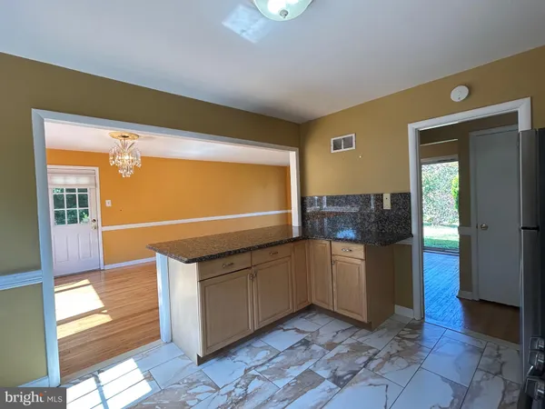 a kitchen with stainless steel appliances granite countertop a sink and a cabinets