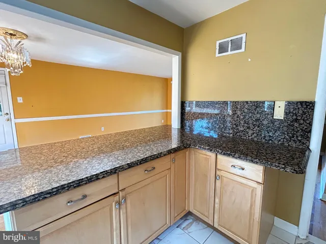 a kitchen with granite countertop a sink and a stove