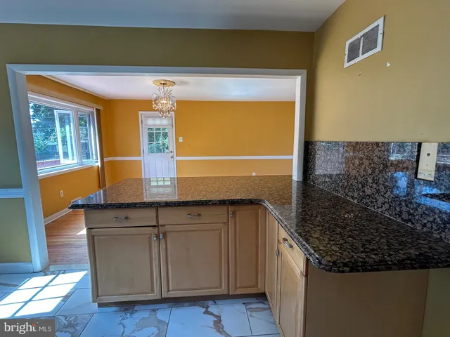 a kitchen with stainless steel appliances granite countertop a sink and a cabinets